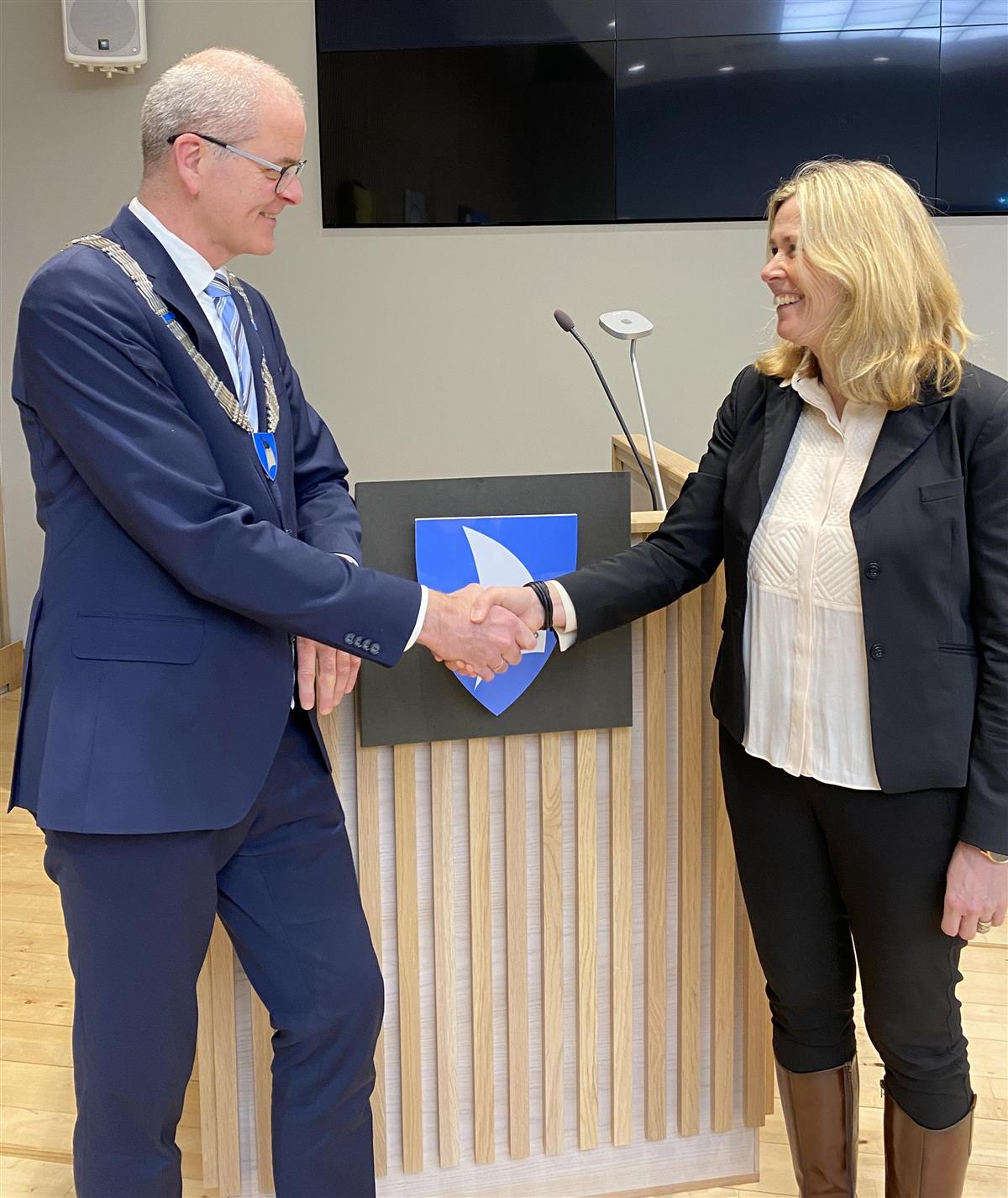 Ordfører Jon Sanness Andersen og Kristin Nilsen trykker hverandres hender - Klikk for stort bilde